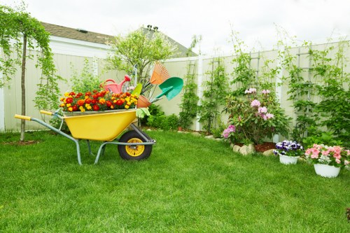 Gardener working in a small Hanwell front garden